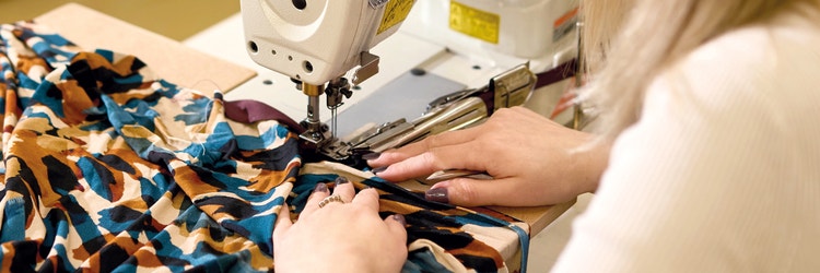 Close up of hands making a David Nieper garment